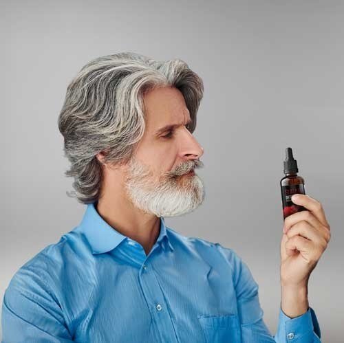 Adult man reviewing bottle