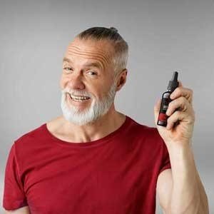 Adult man holding Sugar Defender bottle
